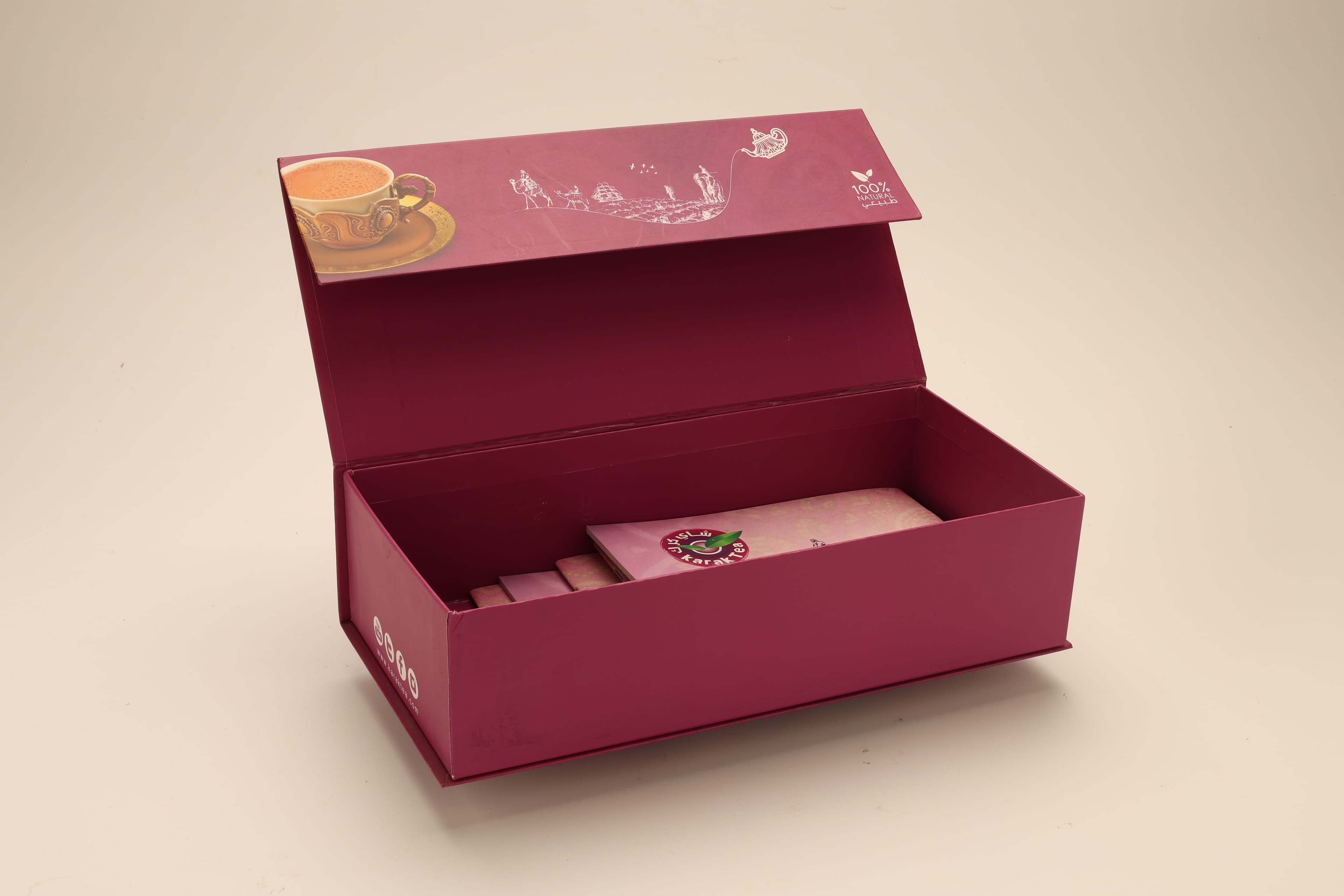 Rigid magnetic-closure gift box in deep magenta with a printed teapot motif, shown open