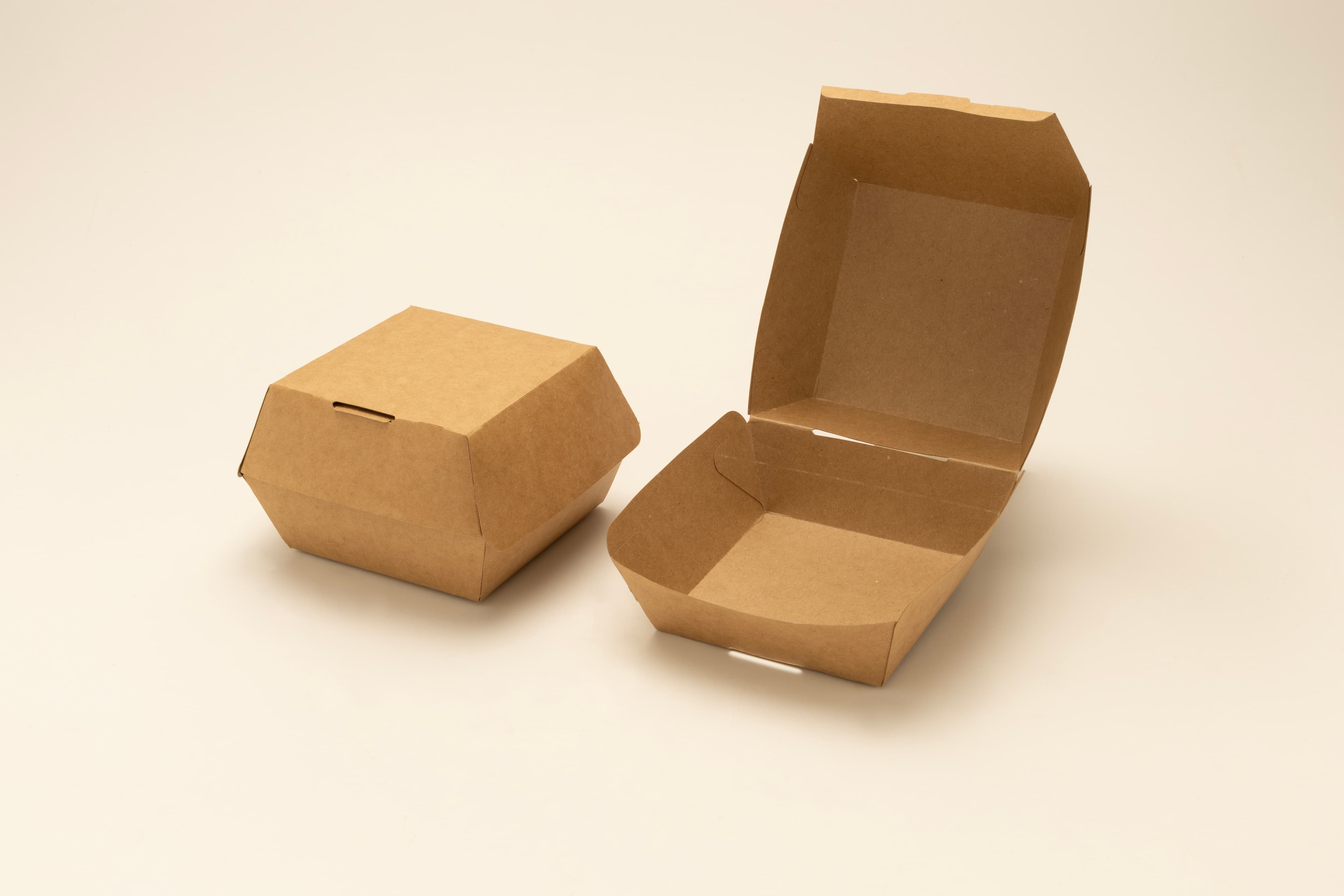 Kraft paperboard burger clamshell box, shown closed and open